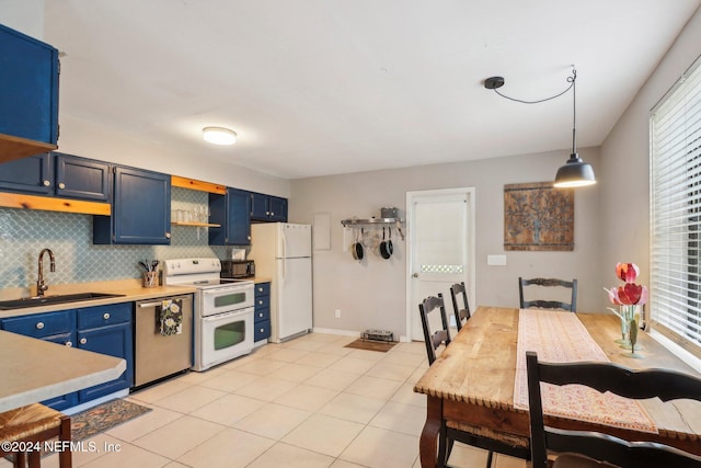 kitchen featuring decorative backsplash, white appliances, a sink, and blue cabinetry