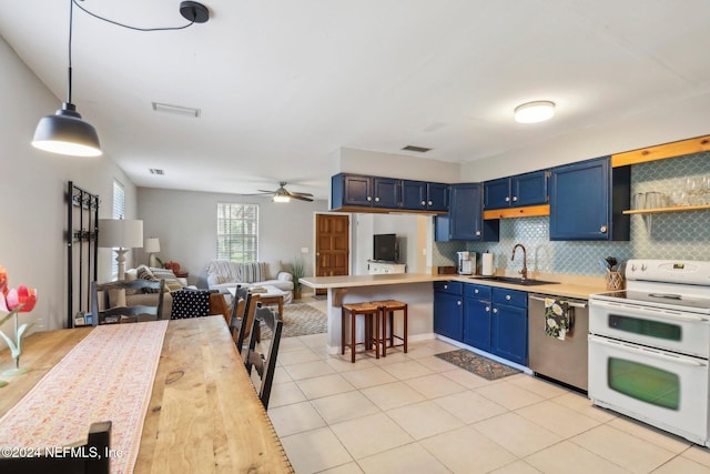 kitchen with light countertops, a sink, blue cabinets, double oven range, and dishwasher