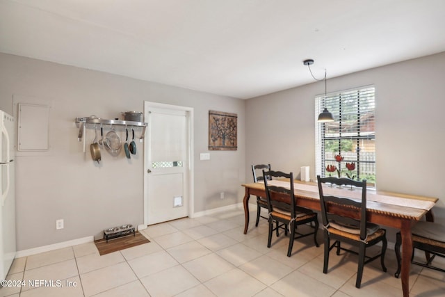 dining space with light tile patterned floors and baseboards