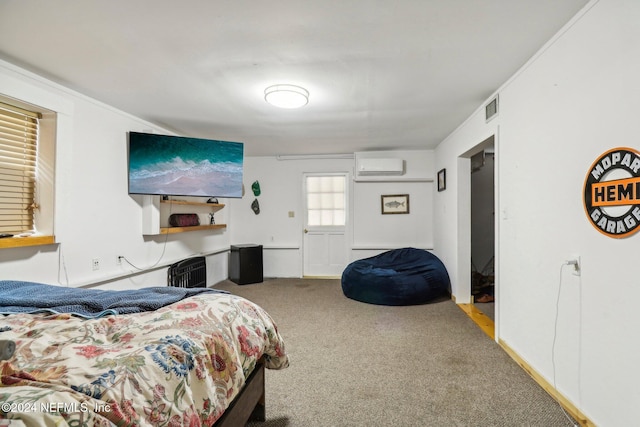 carpeted bedroom with a wall unit AC and visible vents