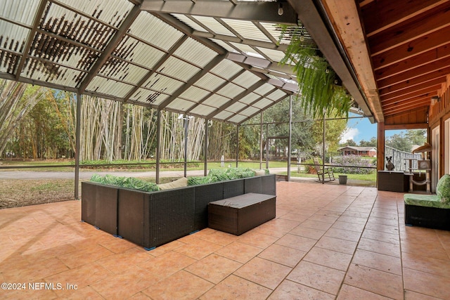 view of patio / terrace featuring a lanai and an outdoor living space