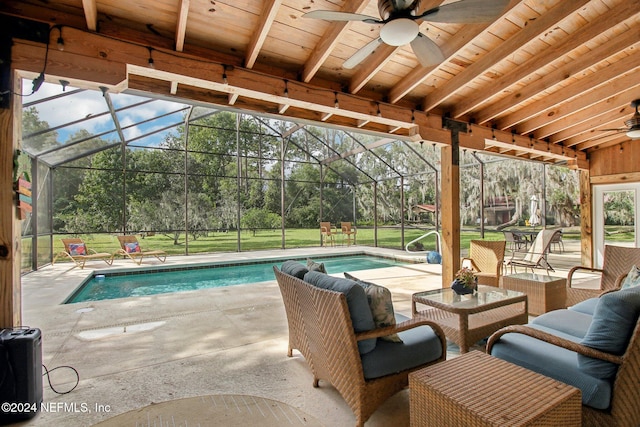 pool with a lawn, glass enclosure, ceiling fan, an outdoor hangout area, and a patio area