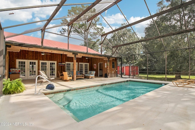 pool featuring french doors, glass enclosure, a patio, and ceiling fan