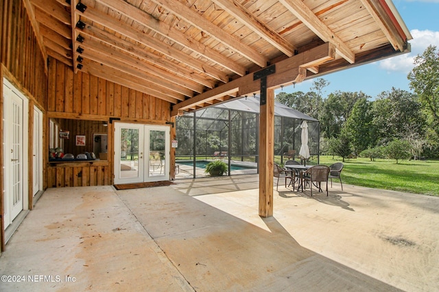 view of patio / terrace featuring a lanai, an outdoor pool, and french doors