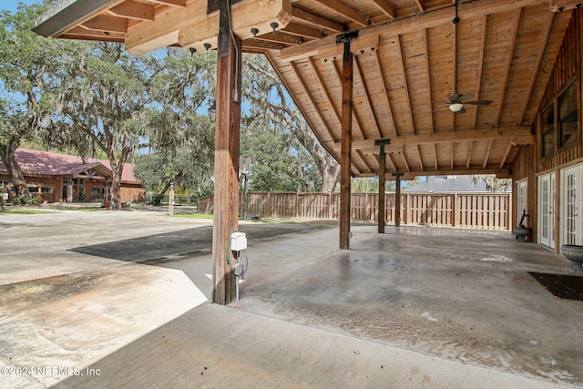 view of patio featuring french doors, ceiling fan, and fence