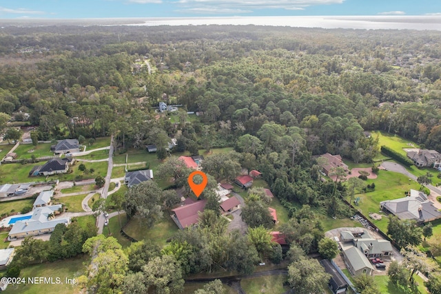 birds eye view of property with a forest view and a residential view