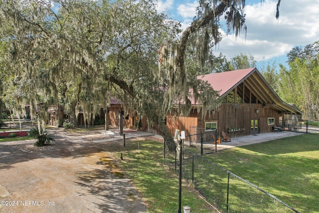 surrounding community with fence and a lawn