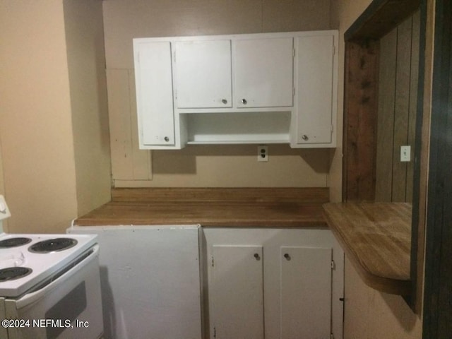 kitchen featuring white cabinets and white range with electric stovetop