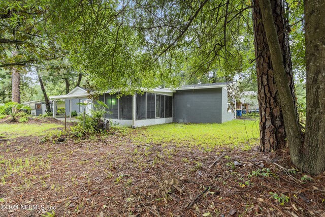 rear view of property with a sunroom