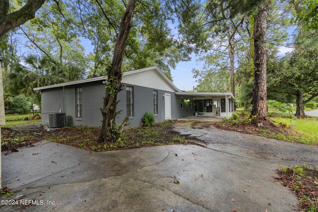 exterior space featuring central AC unit and a carport