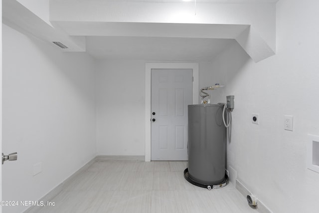 utility room featuring electric water heater