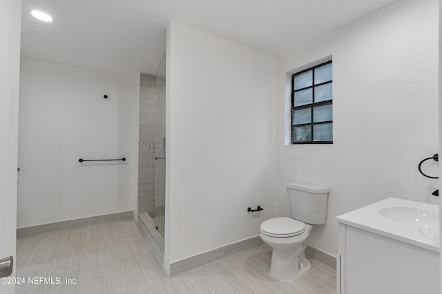 bathroom with vanity, toilet, and walk in shower