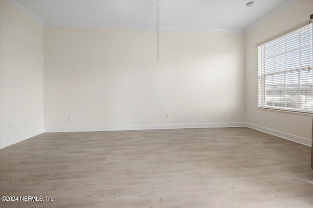 unfurnished room with light wood-type flooring and ornamental molding