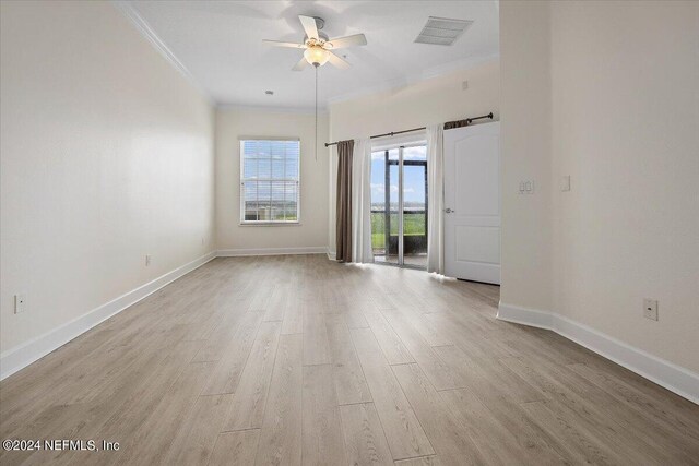 empty room with crown molding, light hardwood / wood-style flooring, and ceiling fan