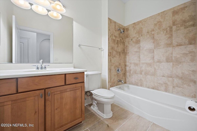 full bathroom with tile patterned floors, tiled shower / bath, toilet, and vanity