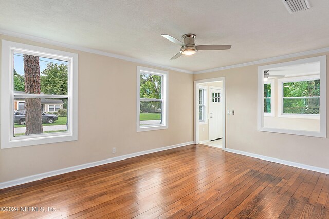 unfurnished room with light wood-type flooring, crown molding, ceiling fan, and a textured ceiling