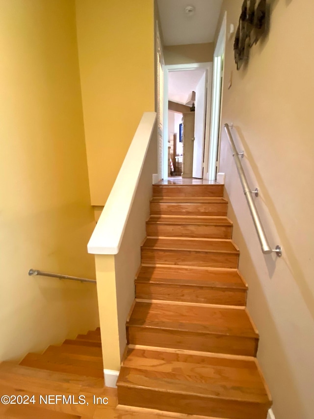 stairway featuring hardwood / wood-style flooring