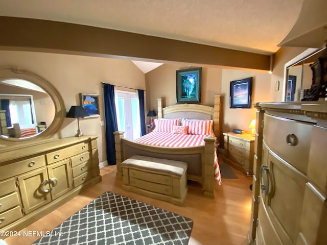 bedroom featuring lofted ceiling and light hardwood / wood-style floors