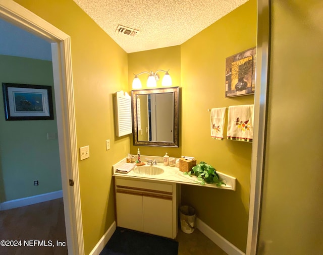 bathroom featuring vanity and a textured ceiling