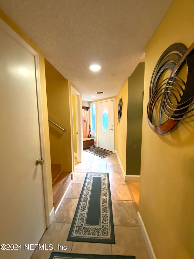 corridor with light tile patterned floors