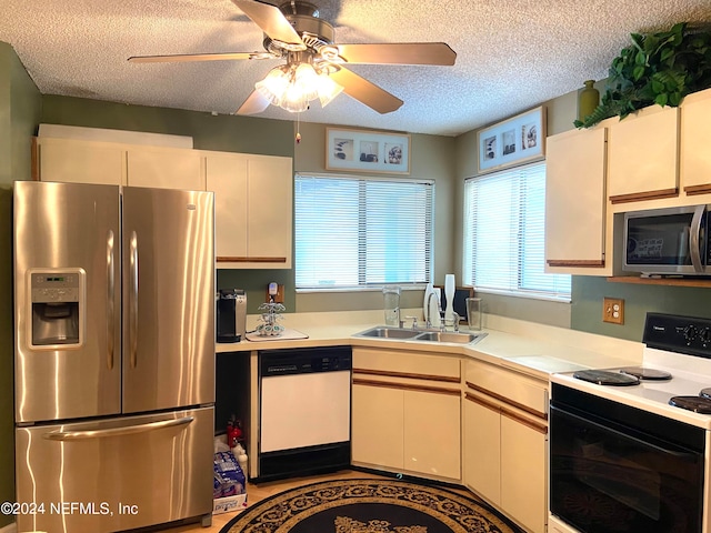 kitchen with ceiling fan, sink, white cabinetry, appliances with stainless steel finishes, and a textured ceiling