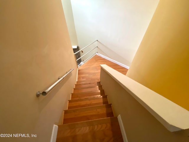 stairs with wood-type flooring