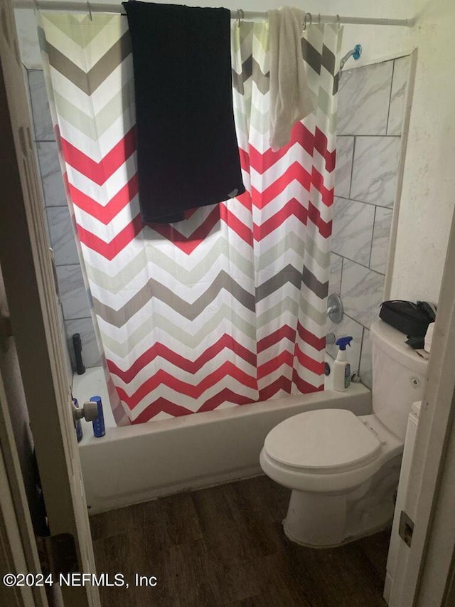 bathroom with toilet, shower / tub combo with curtain, and wood-type flooring