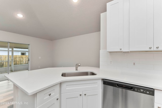 kitchen with light hardwood / wood-style floors, sink, dishwasher, kitchen peninsula, and white cabinetry