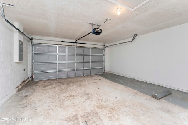 garage with a garage door opener and electric panel