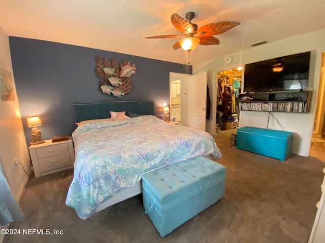 carpeted bedroom with a closet, ceiling fan, and a spacious closet