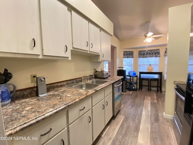 kitchen featuring hardwood / wood-style flooring, stainless steel appliances, white cabinetry, sink, and ceiling fan