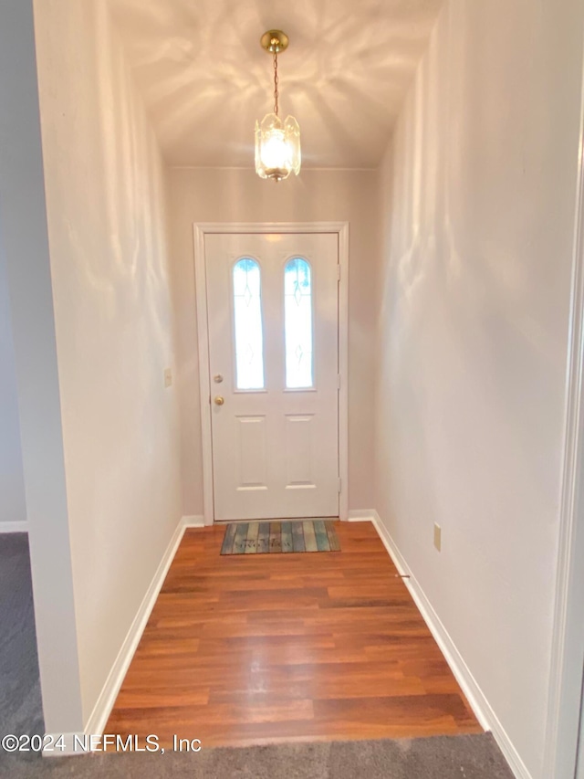 interior space featuring a chandelier and hardwood / wood-style flooring