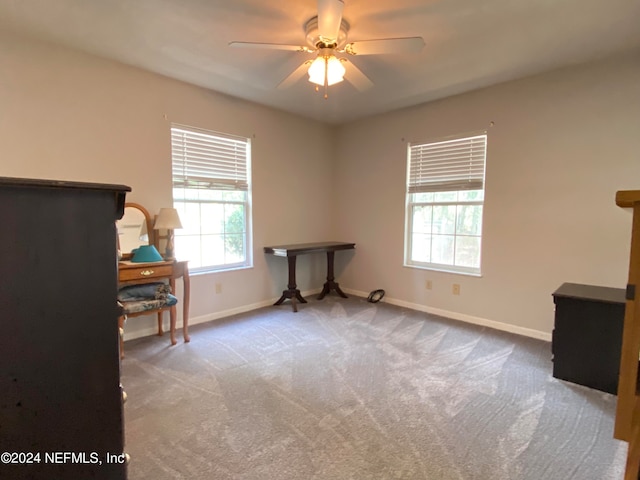 interior space with carpet flooring and ceiling fan