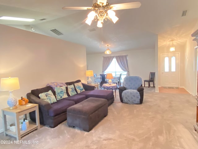 carpeted living room featuring ceiling fan and vaulted ceiling