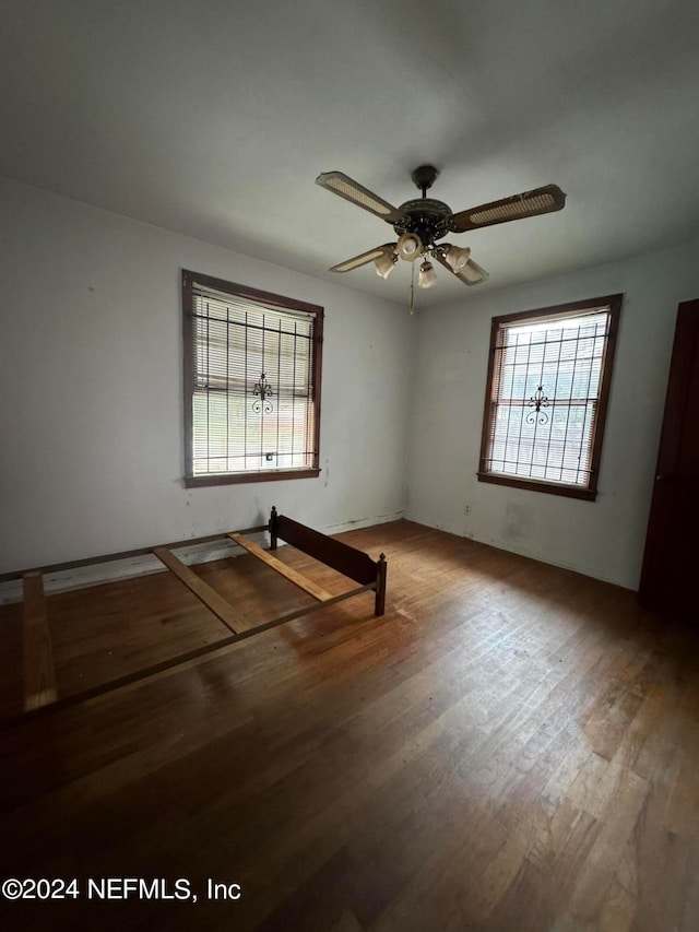 unfurnished room featuring hardwood / wood-style floors and ceiling fan