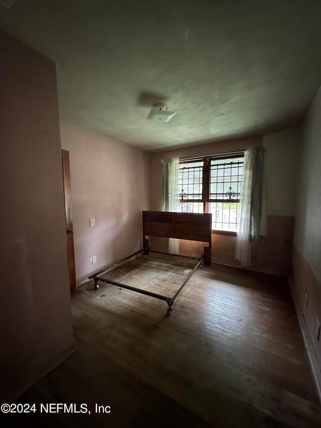 empty room featuring dark wood-type flooring