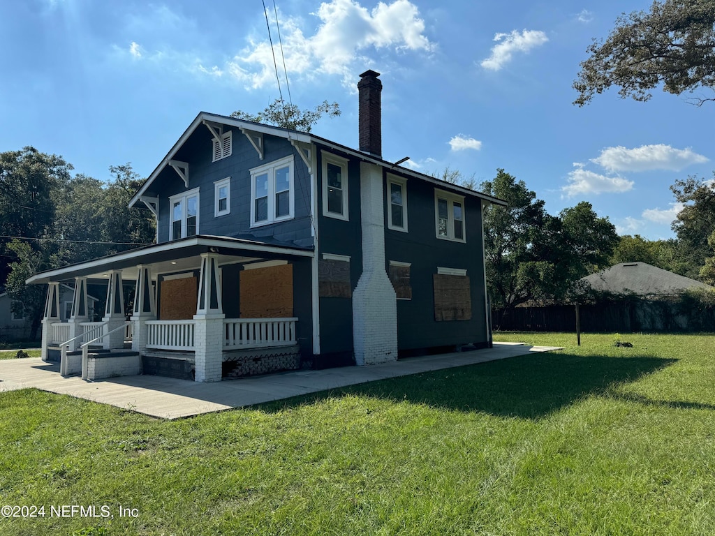 view of property exterior with a porch and a yard