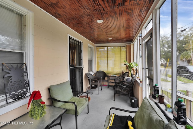 sunroom / solarium with wooden ceiling and a healthy amount of sunlight