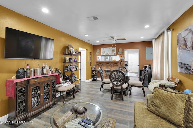 living room featuring ceiling fan and light wood-type flooring