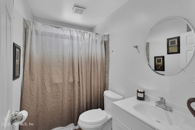 bathroom featuring toilet, walk in shower, and vanity