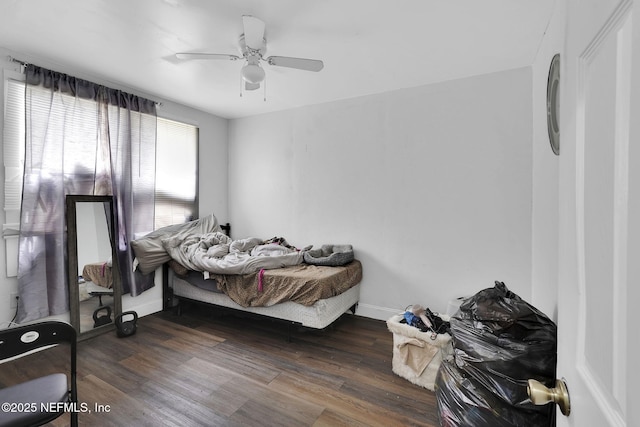 bedroom with ceiling fan and dark hardwood / wood-style flooring