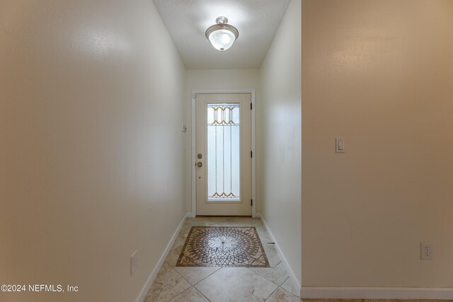 entryway with light tile patterned floors