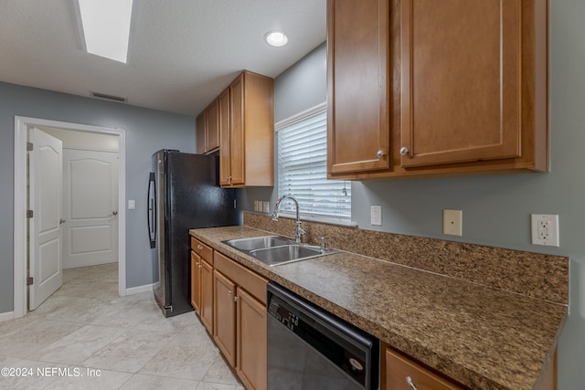 kitchen featuring stainless steel appliances, light tile patterned flooring, and sink