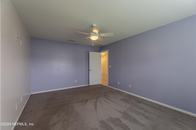 empty room with a textured ceiling, ceiling fan, and carpet floors