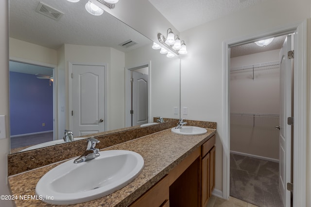 bathroom featuring vanity and a textured ceiling