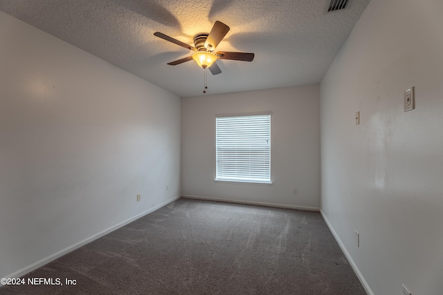 carpeted empty room featuring a textured ceiling and ceiling fan