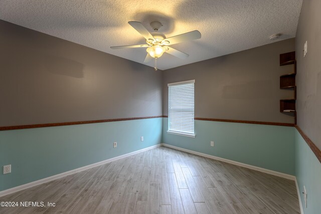 spare room featuring a textured ceiling, light hardwood / wood-style flooring, and ceiling fan