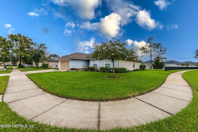 view of front facade featuring a front lawn and a garage