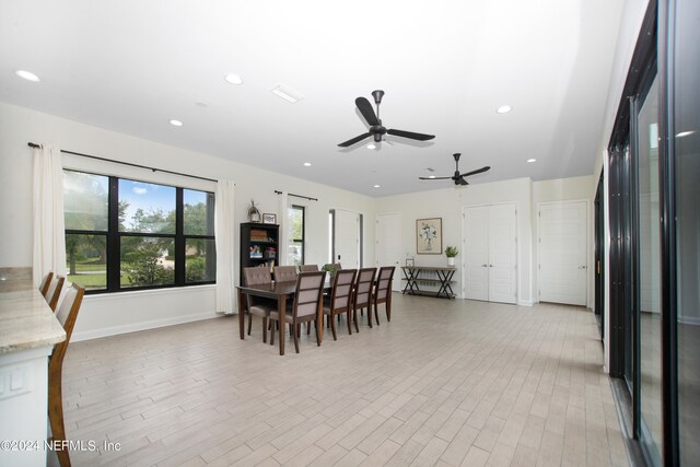 dining area with ceiling fan and light hardwood / wood-style flooring