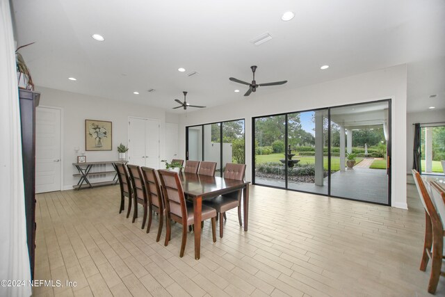 dining area featuring light wood-type flooring and ceiling fan